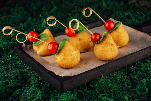 Bolas de queijo saborosas em forma de pêra com tomate