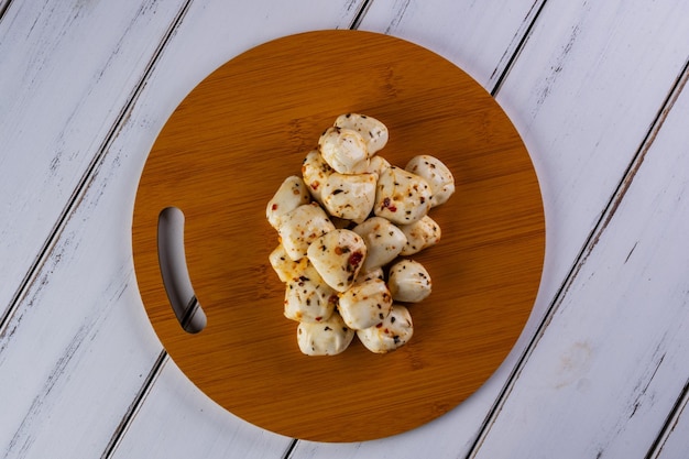 Bolas de mozzarella de búfalo sazonadas en el tablero de aperitivos