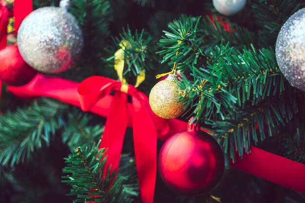 Bolas de Navidad rojas y lazo rojo adornan el árbol de Navidad Fondo de Navidad