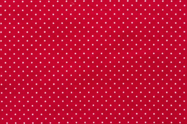 Foto bolinhas em fundo de tecido de textura de algodão de lona vermelha