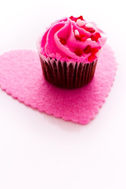 Bolinho de chocolate com glacê rosa decorado para o dia dos namorados.