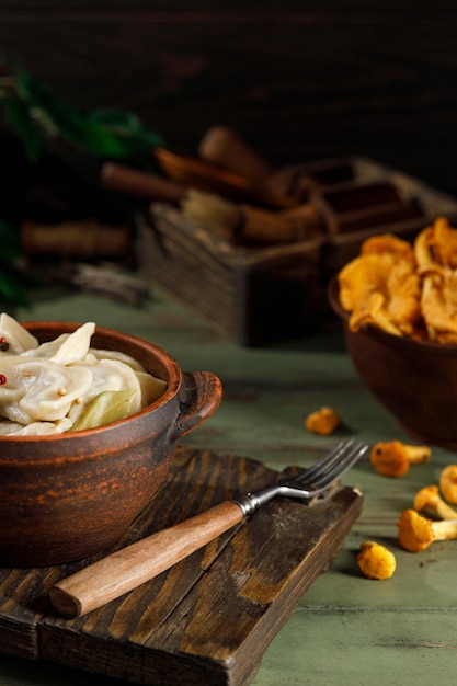 Bolinhos prontos com batatas e cogumelos em um prato na mesa. com fumaça. metade na metade