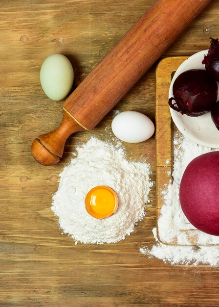 Bollo de masa púrpura para fideos con ingredientes sobre la mesa