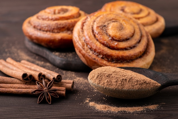 Bollos caseros con canela con algunas especias a tierra en shoon de madera. Cocinar en casa