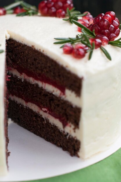 Bolo de chocolate com creme de bagas creme de queijo branco bagas de romã e ramos de alecrim Ideia para um bolo de aniversário ou para um bolo de casamentoxA