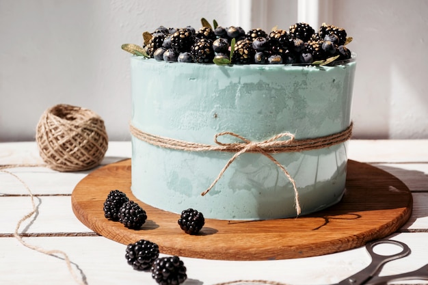 Foto bolo de creme turquesa com mirtilos e amoras, ainda vida home cozimento, negócios