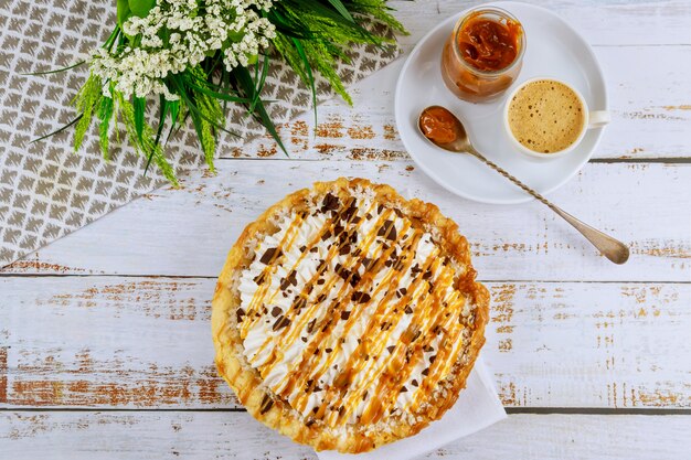 Bolo de festa saborosa na mesa branca com molho de caramelo