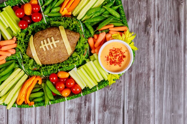 Bolo de futebol com legumes e molho para a festa dos fãs do Super Bowl