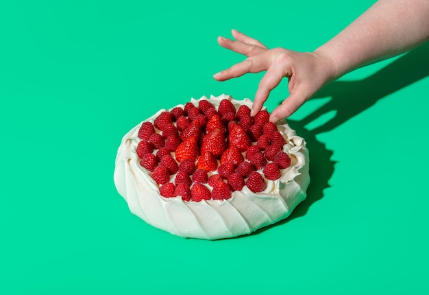 Bolo Pavlova com frutas frescas isoladas em um fundo verde Bolo de merengue caseiro