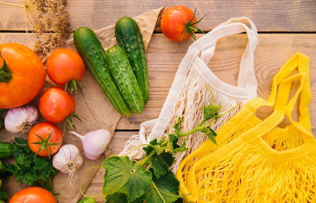 Bolsa de compras reutilizable hecha de materiales reciclados en una mesa de madera entre verduras frescas Sin plástico Estilo de vida ecológico