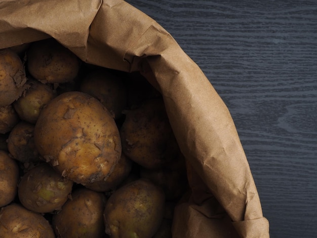 Una bolsa marrón de papas en un fondo negro