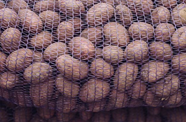 Una bolsa de papas crudas y sucias.