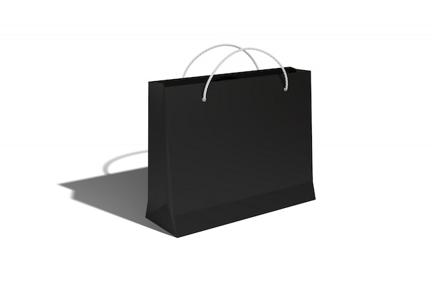 bolsa de papel de cartón para comprar zanahorias en una tienda de descuento y para la venta en negro proyecta una sombra sobre un aislante blanco.