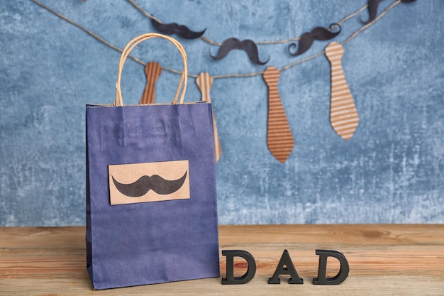 Bolsa de papel con regalo para el día del padre en la mesa.