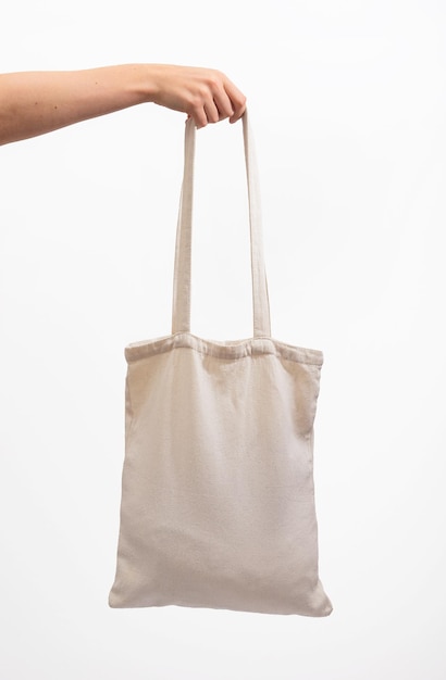 Foto bolsa de tote en la mano aislada en blanco de algodón textil natural modelo de comprador ecológico