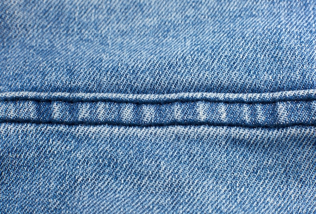 Bolsillo de material de jeans azul hipster. Fondo de textura de tela de mezclilla.