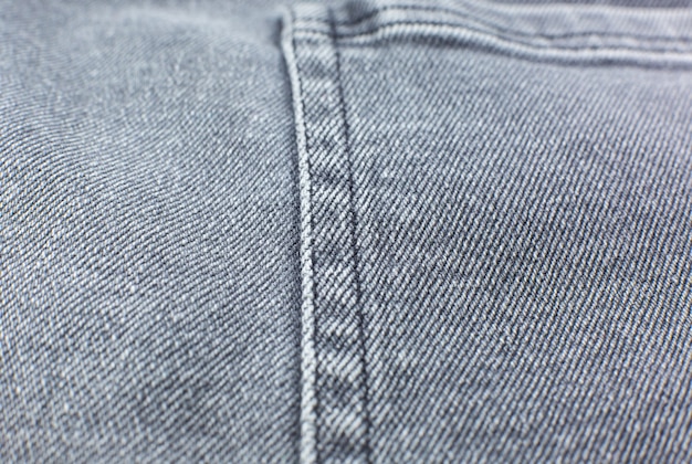 Bolsillo de material jeans gris hipster. Fondo de textura de tela gris.