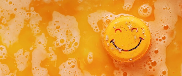 Bomba de baño naranja en agua con sonrisa feliz