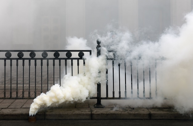 Bomba de humo humeante en la carretera durante la acción de protesta