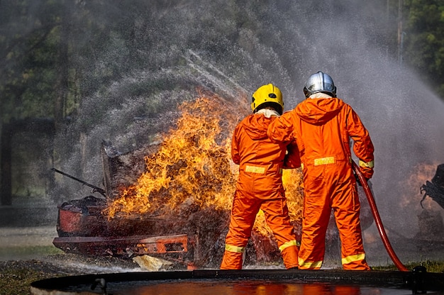 Bombeiros pulverizando água a alta pressão para disparar