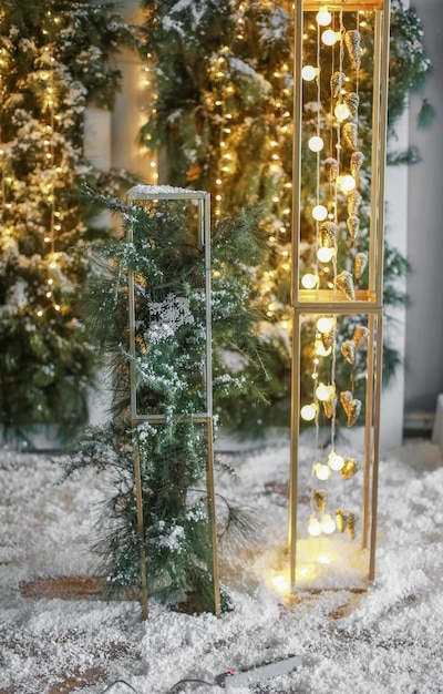 Bombillas de luz que brilla intensamente de color amarillo de Navidad sobre un fondo de árbol verde