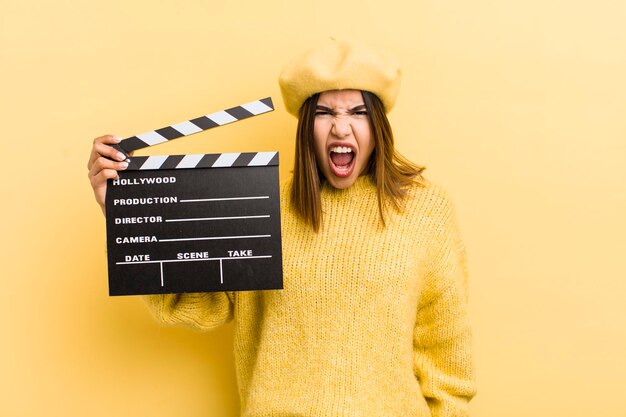 Bonita chica hispana gritando agresivamente con un concepto de cine muy enojado