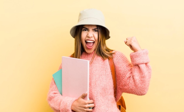 Bonita chica hispana gritando agresivamente con un concepto de estudiante de expresión enojada