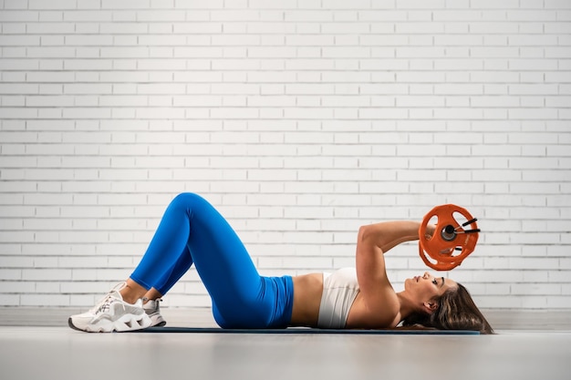 Una bonita mujer caucásica haciendo ejercicio en el gimnasio.