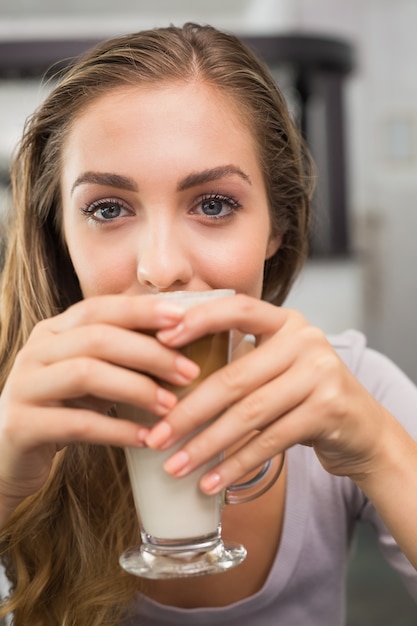 Bonita rubia disfrutando de un café con leche