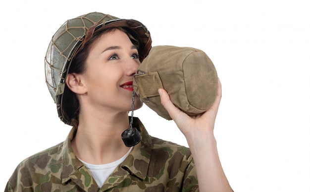 Foto bonito, mulher jovem, em, ww2, americano, uniforme, bebendo, água