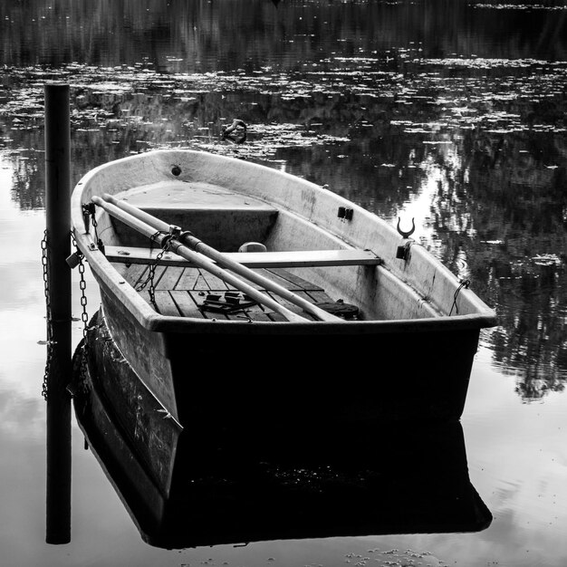 Foto boot, das an einem pfahl im see verankert ist