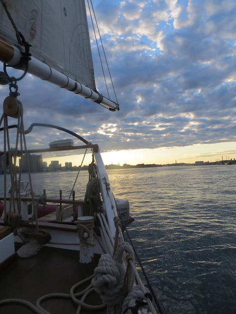 Boote auf See gegen wolkigen Himmel bei Sonnenuntergang