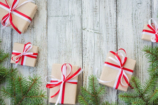 Borda das caixas de presente de Natal e galho de árvore do abeto na mesa de madeira