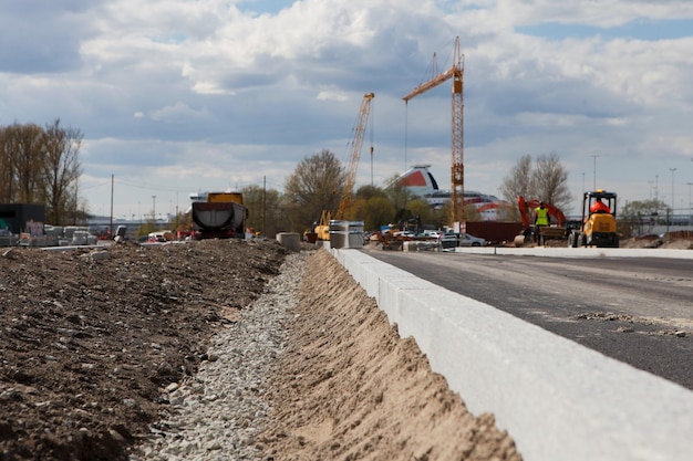 Bordillo en el sitio de construcción de carreteras Nuevos bordillos después de pavimentar Reparación de carreteras y base de escombros