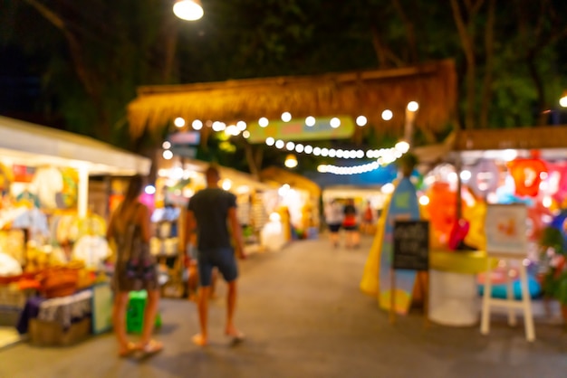 Foto borrão abstrata e mercado de rua à noite desfocado