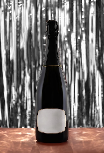 Foto botella de champán con fondo plateado abstracto