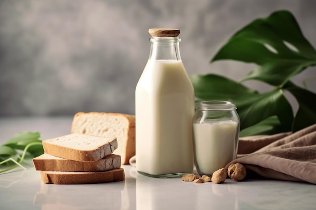 Una botella de leche de almendras y pan sobre una mesa.