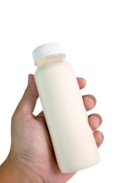 Foto botella de leche en mano aislado en blanco