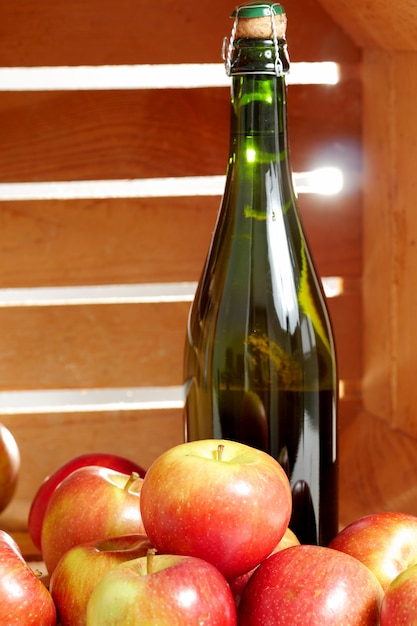 Botella de sidra con manzanas frescas