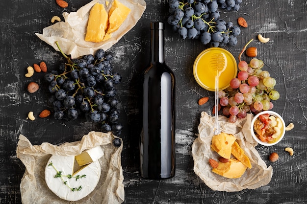 Botella de vino tinto vino y composición de alimentos ingredientes de gastronomía diferentes uvas de queso