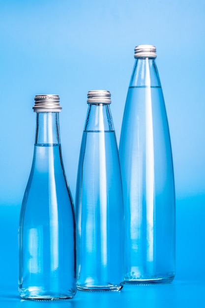 Botellas de agua de vidrio en azul claro