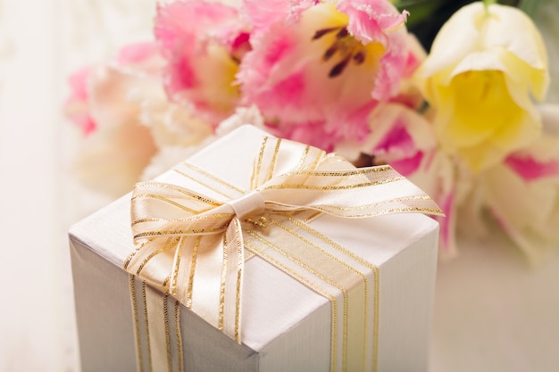 Box mit Geschenk und Tulpen für Mama