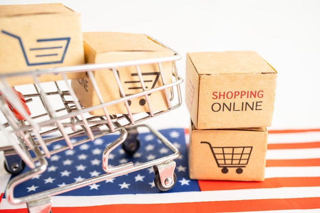 Box mit Shopping-Online-Warenkorb-Logo und USA-Amerika-Flagge Import Export Shopping Online- oder Handelsfinanz-Lieferservice Store-Produktversand Handelslieferantenkonzept