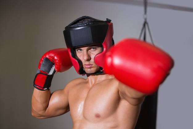 Boxeador masculino atacando com a esquerda no clube de saúde