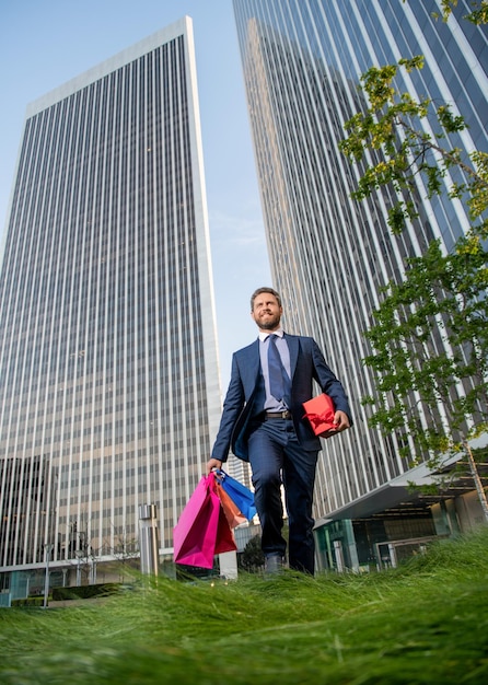 Boxing day hombre guapo con caja presente empresario sonriente llevar regalo de cumpleaños