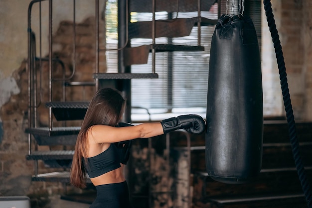 Boxtraining der jungen Frau im Fitnessstudio