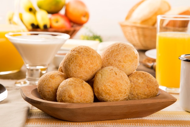 Brasilianische Käsebrötchen. Tischcafé am Morgen mit Käsebrot und Obst.