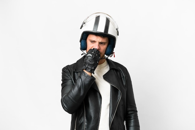 Brasilianischer Mann mit Motorradhelm vor isoliertem weißem Hintergrund, der Zweifel hat