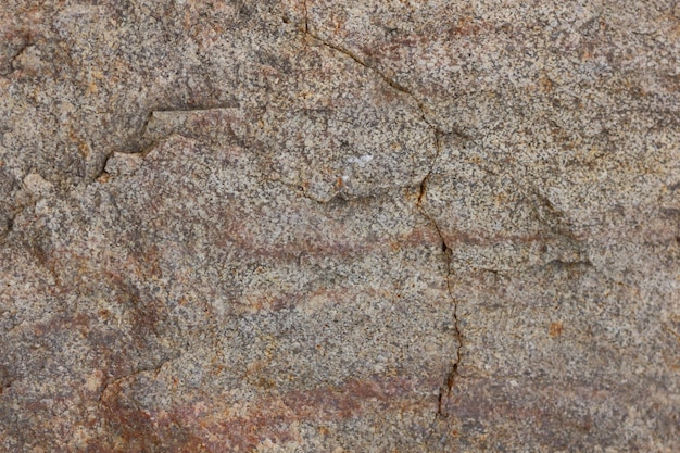 Brauner Stein oder Felshintergrund Grobe braune Steinmauer Detailansicht der strukturierten verwitterten Oberfläche