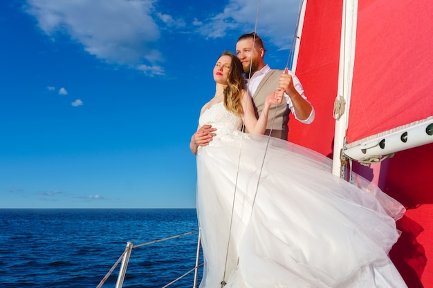 Brautpaar bei einer Hochzeitsreise ans Meer auf einer Segelyacht